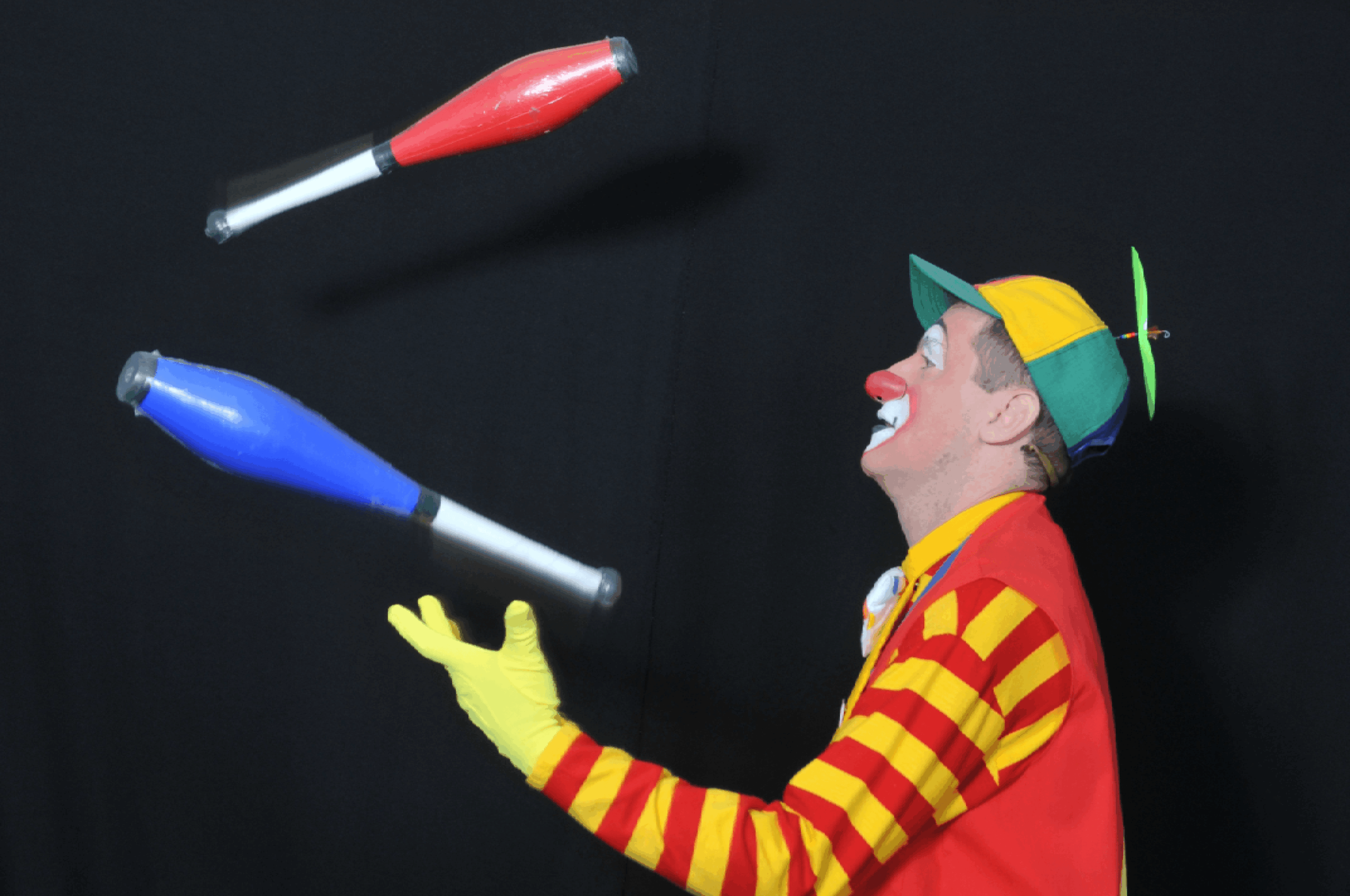 Entertainer juggling two clubs